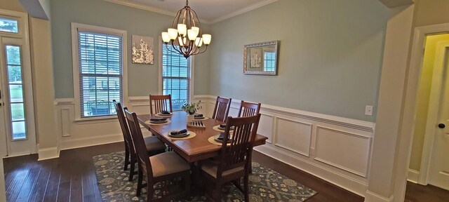 dining room featuring dark hardwood / wood-style flooring, crown molding, and a chandelier