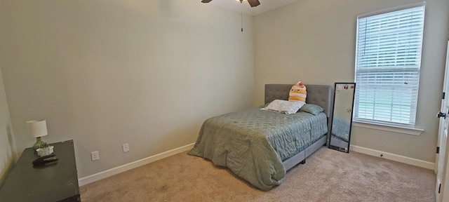 bedroom with light carpet and ceiling fan