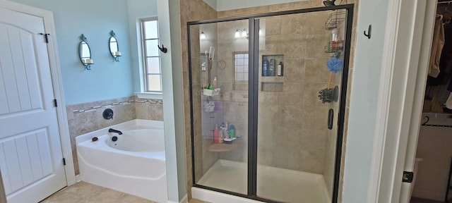 bathroom featuring tile patterned flooring and independent shower and bath