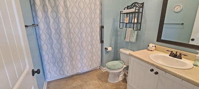 bathroom featuring vanity, a shower with shower curtain, tile patterned floors, and toilet