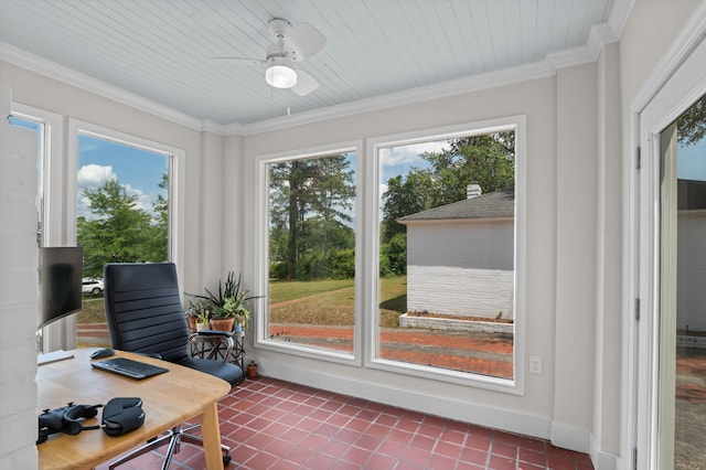 interior space featuring a healthy amount of sunlight, dark tile patterned floors, crown molding, and ceiling fan