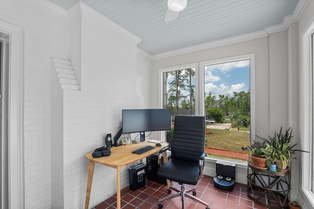 home office with crown molding, dark tile patterned floors, and brick wall