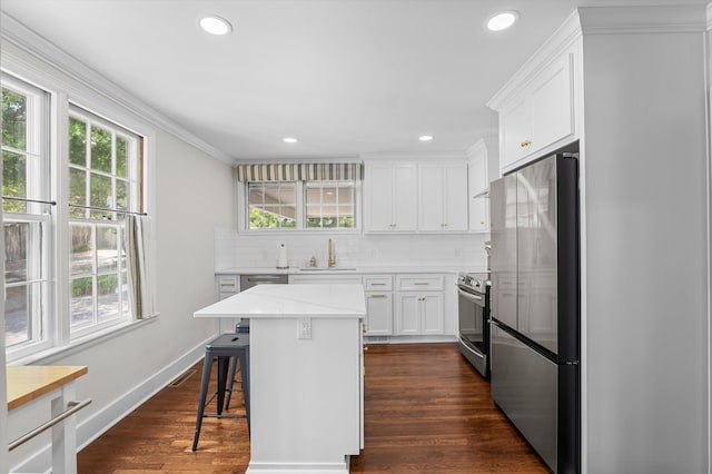kitchen featuring plenty of natural light, a sink, and stainless steel appliances