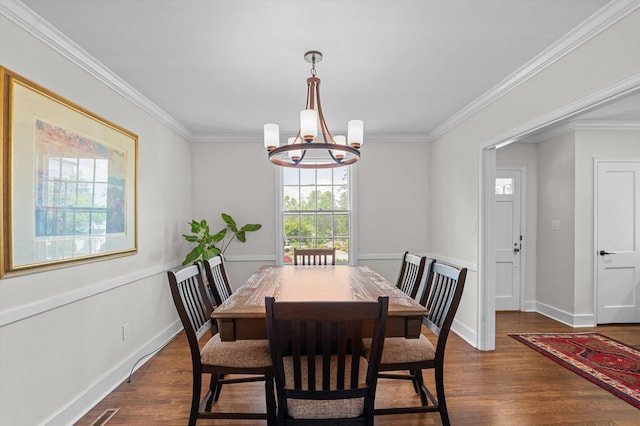 dining area featuring crown molding, a notable chandelier, and dark wood-type flooring