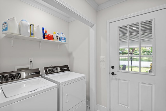 laundry room featuring crown molding, separate washer and dryer, baseboards, and laundry area