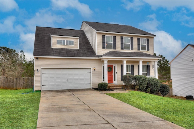 view of front of property with a front lawn and a garage