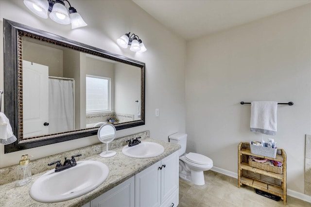 bathroom featuring toilet, a shower with curtain, and vanity