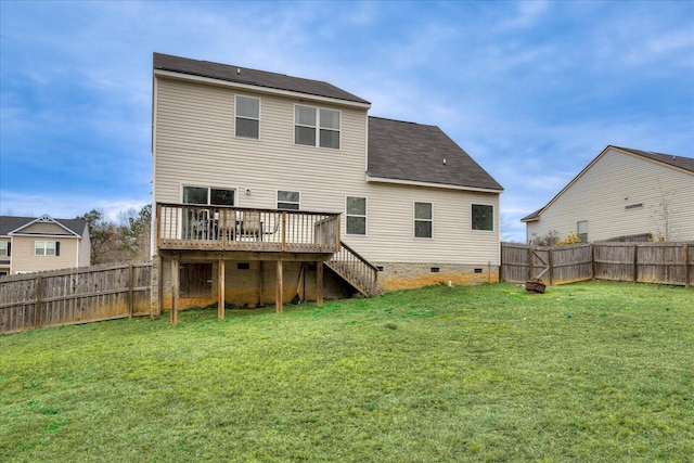 back of house featuring a lawn and a wooden deck