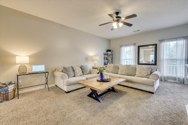 living room featuring carpet flooring, ceiling fan, and a wealth of natural light