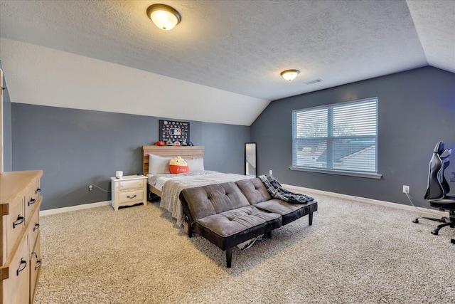 carpeted bedroom with a textured ceiling and vaulted ceiling