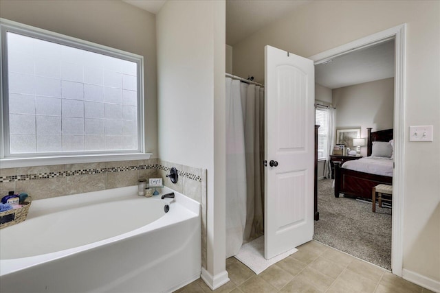 bathroom featuring tile patterned flooring and independent shower and bath