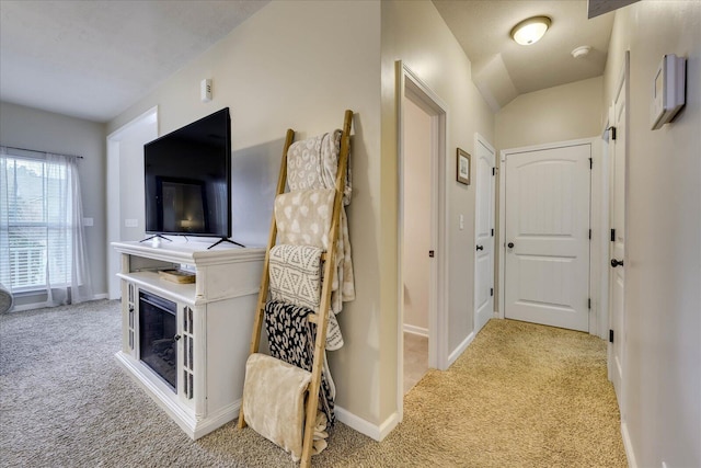 hallway featuring light colored carpet