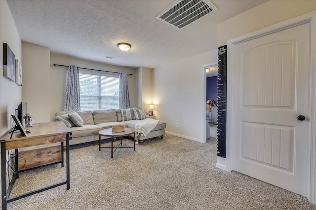 carpeted living room featuring a textured ceiling