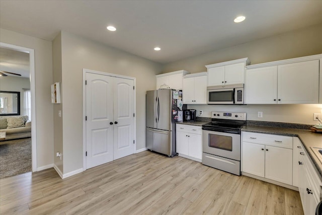 kitchen with white cabinets, light wood-type flooring, appliances with stainless steel finishes, and ceiling fan