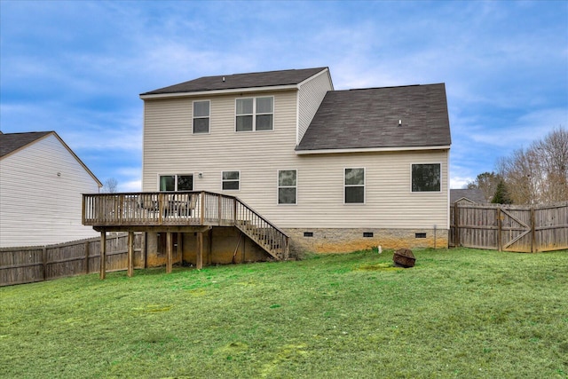 back of house featuring a deck and a lawn