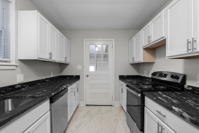 kitchen with white cabinetry, sink, appliances with stainless steel finishes, and dark stone counters