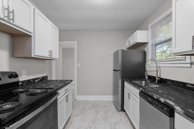 kitchen featuring white cabinetry, sink, dark stone counters, and appliances with stainless steel finishes