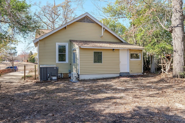 rear view of property featuring central AC unit