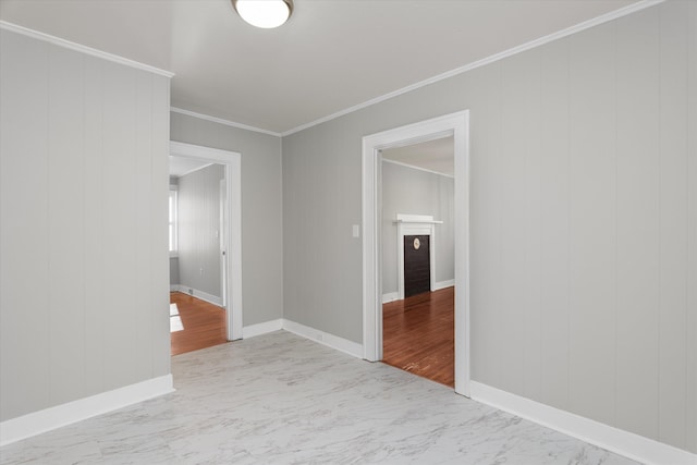 unfurnished room featuring wooden walls and ornamental molding