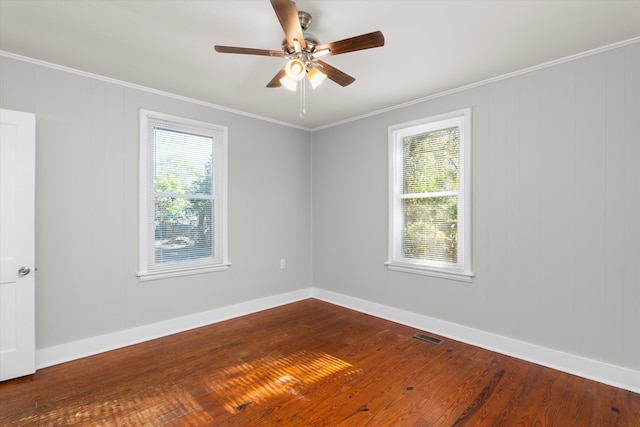 empty room featuring hardwood / wood-style flooring, ceiling fan, and ornamental molding