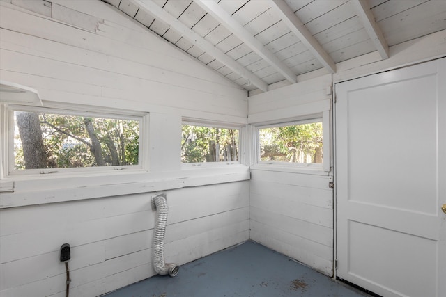 unfurnished sunroom featuring vaulted ceiling with beams and wood ceiling