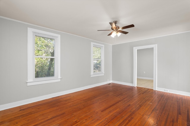 unfurnished room with ceiling fan, crown molding, and wood-type flooring