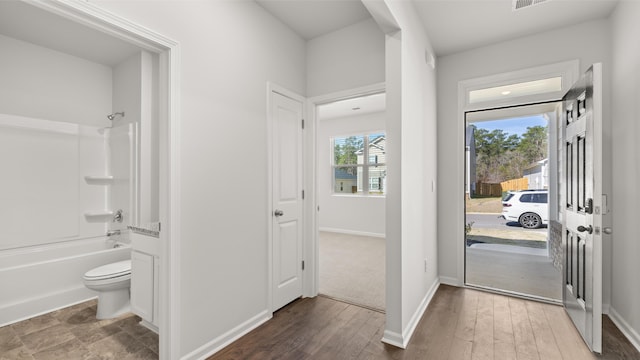 entrance foyer with baseboards and wood finished floors