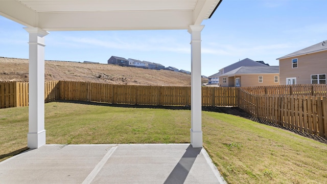 view of yard with a patio, a residential view, and a fenced backyard