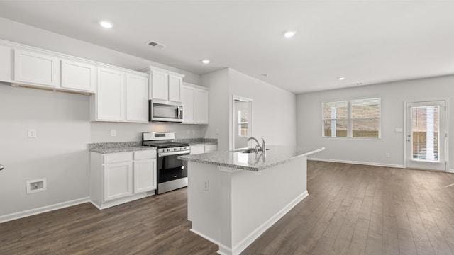 kitchen featuring dark wood-style floors, white cabinetry, visible vents, and appliances with stainless steel finishes