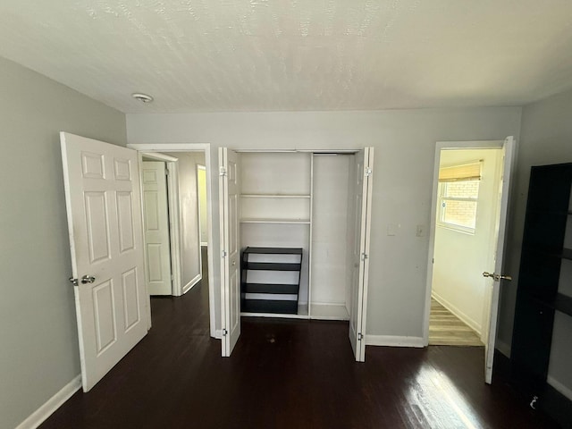 3314 Forest Estates Dr, Augusta, GA 30909 - unfurnished bedroom featuring dark wood-style floors, baseboards, and a closet