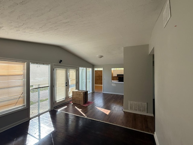 3314 Forest Estates Dr, Augusta, GA 30909 - unfurnished room featuring baseboards, lofted ceiling, wood finished floors, plenty of natural light, and a textured ceiling