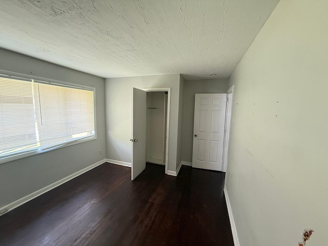 3314 Forest Estates Dr, Augusta, GA 30909 - unfurnished bedroom with wood finished floors, baseboards, a closet, and a textured ceiling