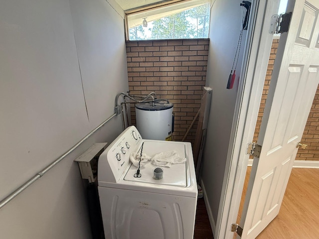 3314 Forest Estates Dr, Augusta, GA 30909 - laundry room featuring washer / clothes dryer, water heater, light wood-style flooring, and baseboards