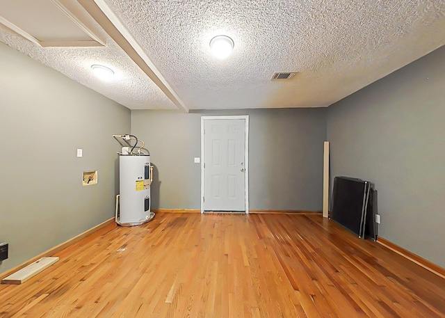 5850 Jaime Dr, Grovetown, GA 30813 - basement with electric water heater, light wood finished floors, and a textured ceiling