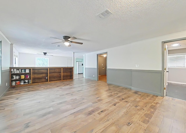 5850 Jaime Dr, Grovetown, GA 30813 - unfurnished living room with light wood finished floors, a ceiling fan, and a textured ceiling