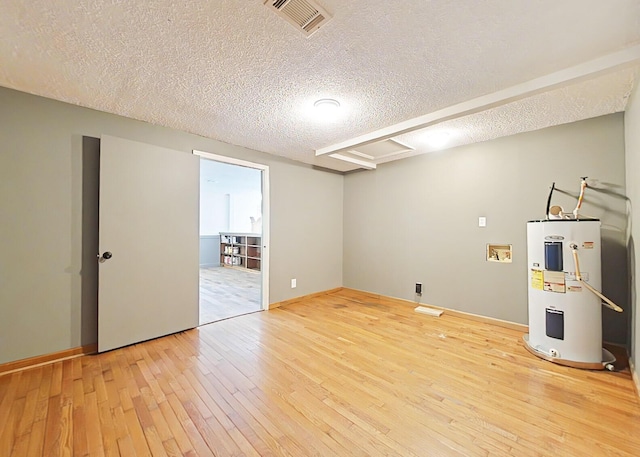 5850 Jaime Dr, Grovetown, GA 30813 - below grade area featuring water heater, a textured ceiling, and light wood-style flooring