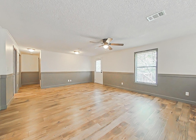 5850 Jaime Dr, Grovetown, GA 30813 - spare room with a textured ceiling, light wood finished floors, a ceiling fan, and a wainscoted wall