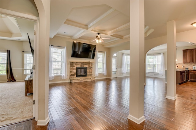 336 Shell Brooke Way, Lexington, SC 29073 - unfurnished living room with arched walkways, a ceiling fan, wood finished floors, coffered ceiling, and baseboards