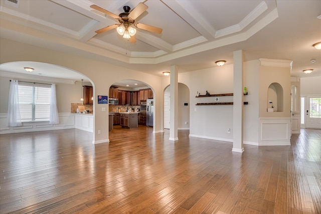336 Shell Brooke Way, Lexington, SC 29073 - unfurnished living room featuring ceiling fan, arched walkways, ornamental molding, dark wood-style flooring, and beam ceiling