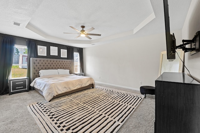 3235 Warwick Pl, Hephzibah, GA 30815 - carpeted bedroom with a textured ceiling, a raised ceiling, multiple windows, and ceiling fan