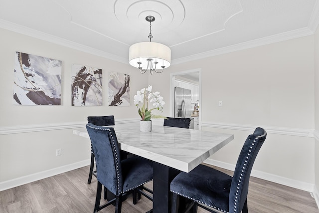 3235 Warwick Pl, Hephzibah, GA 30815 - dining space featuring wood finished floors, ornamental molding, and a chandelier