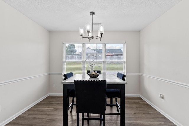 3235 Warwick Pl, Hephzibah, GA 30815 - dining room featuring a chandelier, dark wood-type flooring, and a textured ceiling