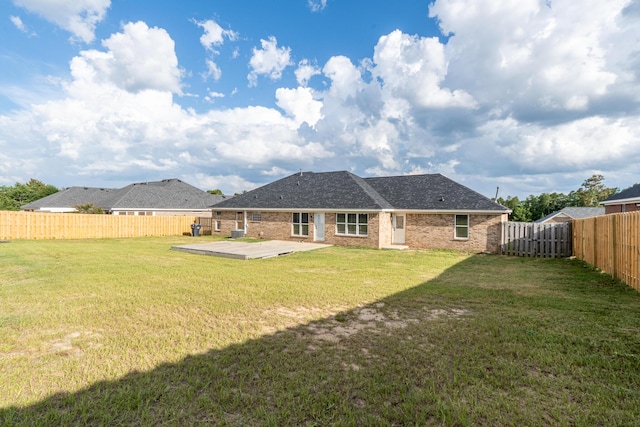 3235 Warwick Pl, Hephzibah, GA 30815 - rear view of house with a fenced backyard, brick siding, and a patio area