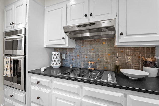 2801 Peachtree Pl, Augusta, GA 30909 - kitchen featuring under cabinet range hood, stainless steel appliances, white cabinetry, and dark countertops