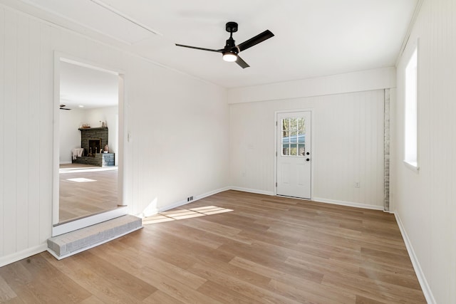 unfurnished room with ceiling fan and light wood-type flooring