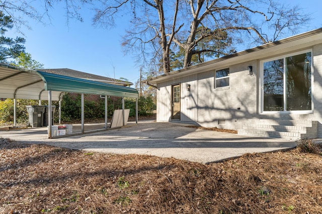 view of side of property with a carport