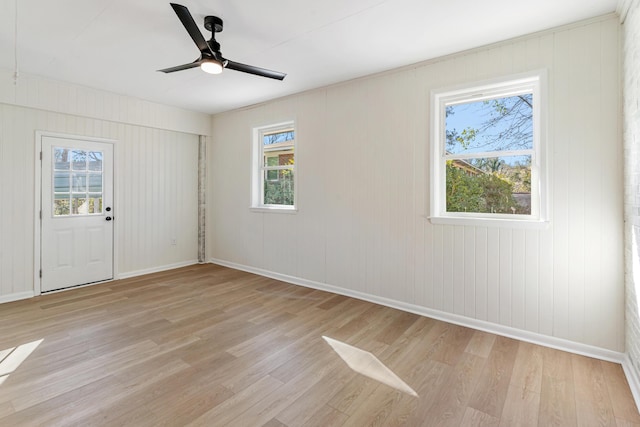 empty room featuring ceiling fan and light hardwood / wood-style floors