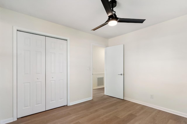 unfurnished bedroom with ceiling fan, a closet, and light hardwood / wood-style flooring