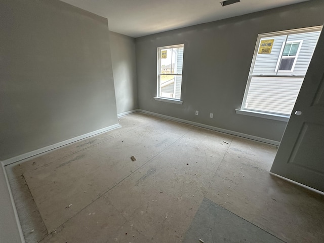 spare room featuring baseboards