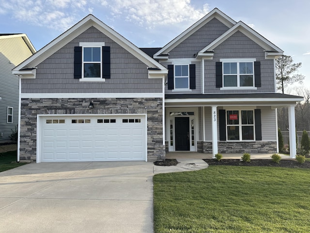 craftsman-style home featuring a porch, stone siding, and a front lawn